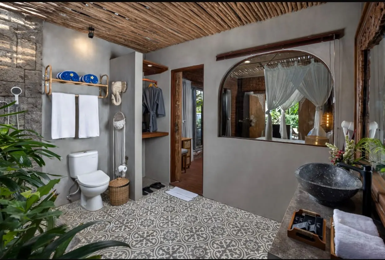 Bathroom with patterned tiles and stone basin