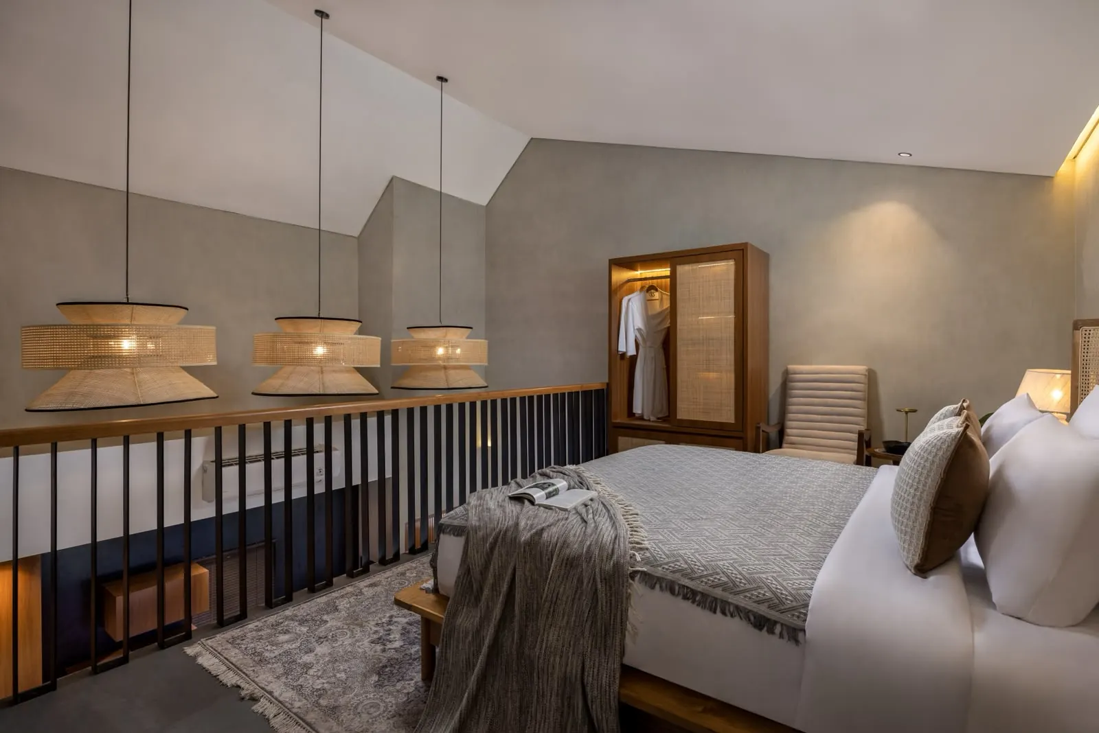 Mezzanine bedroom with woven pendant lamps and steel railing