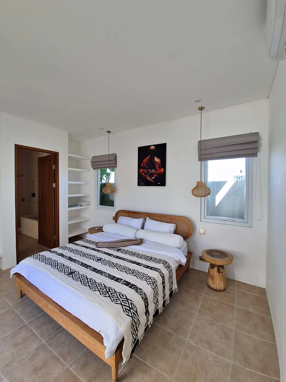Bedroom with teak bed, rattan pendants and AC
