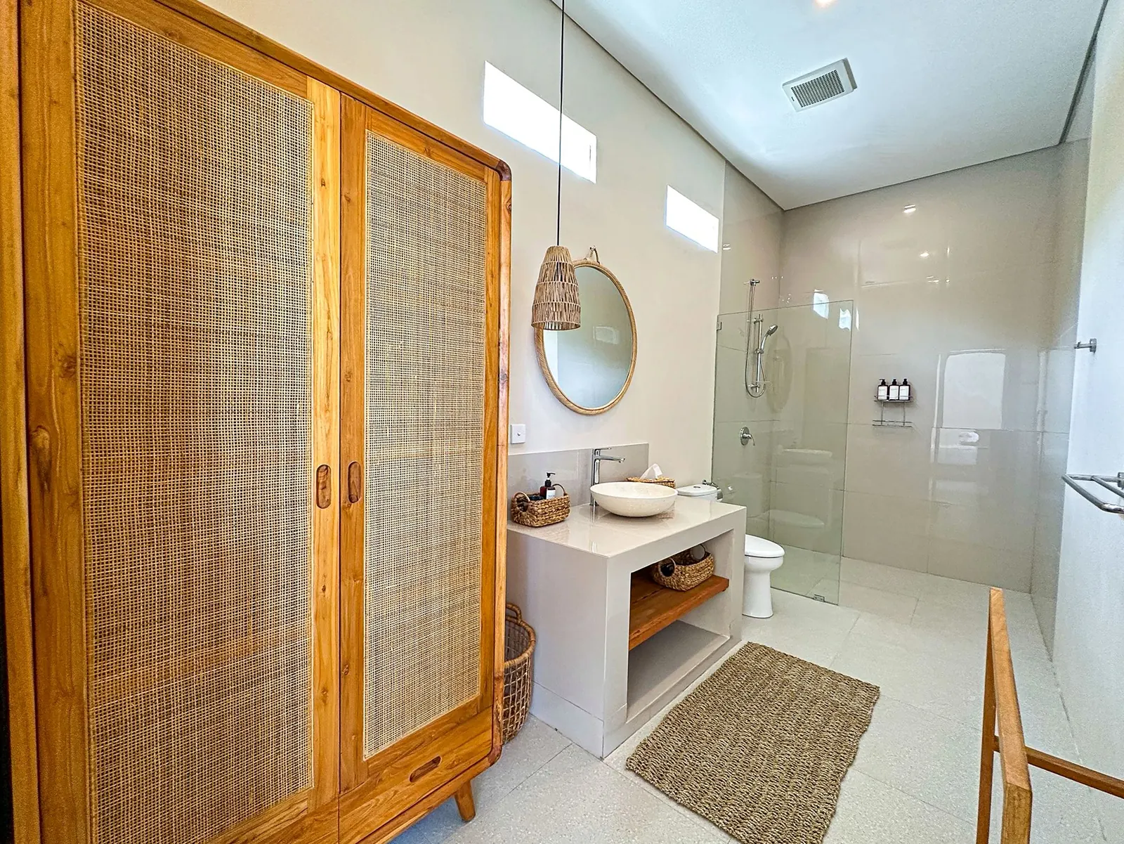 Ensuite bathroom with rattan wardrobe and walk-in shower