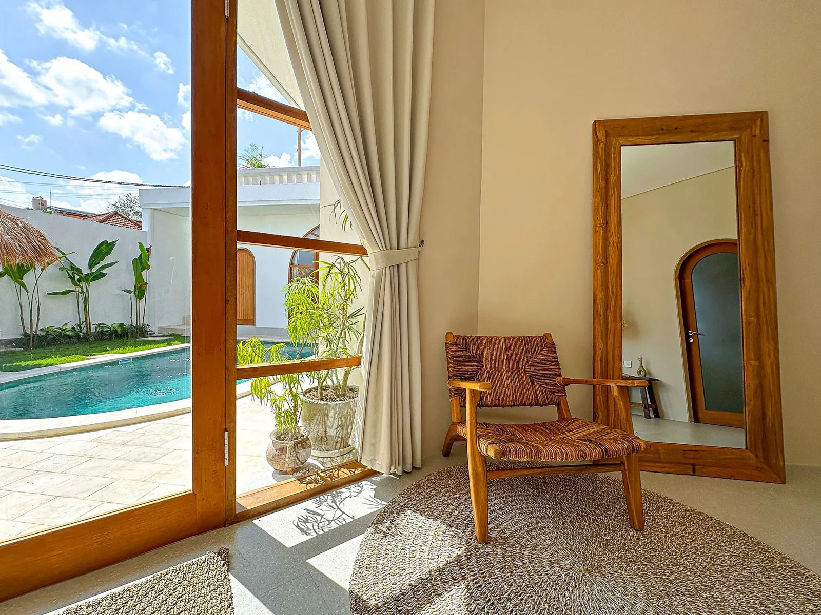 Chair by the glass door with pool view