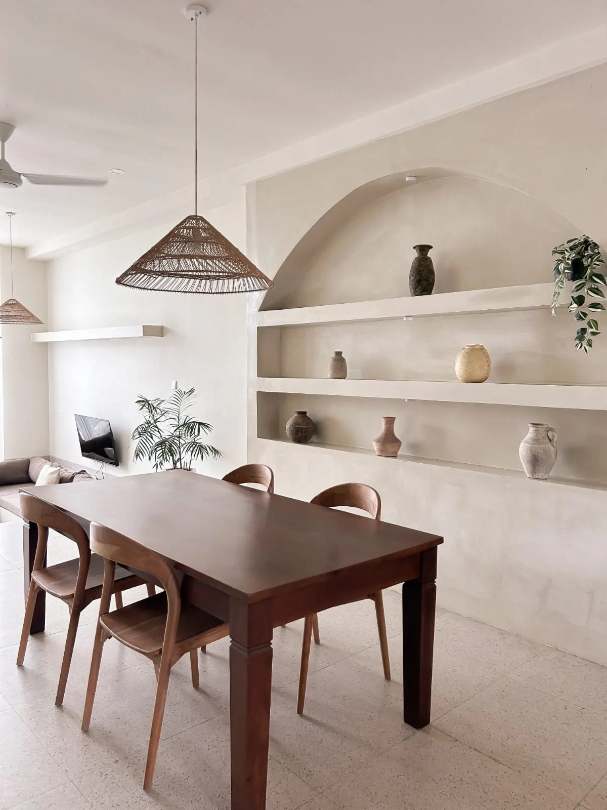 Dining area with arched niches and vases