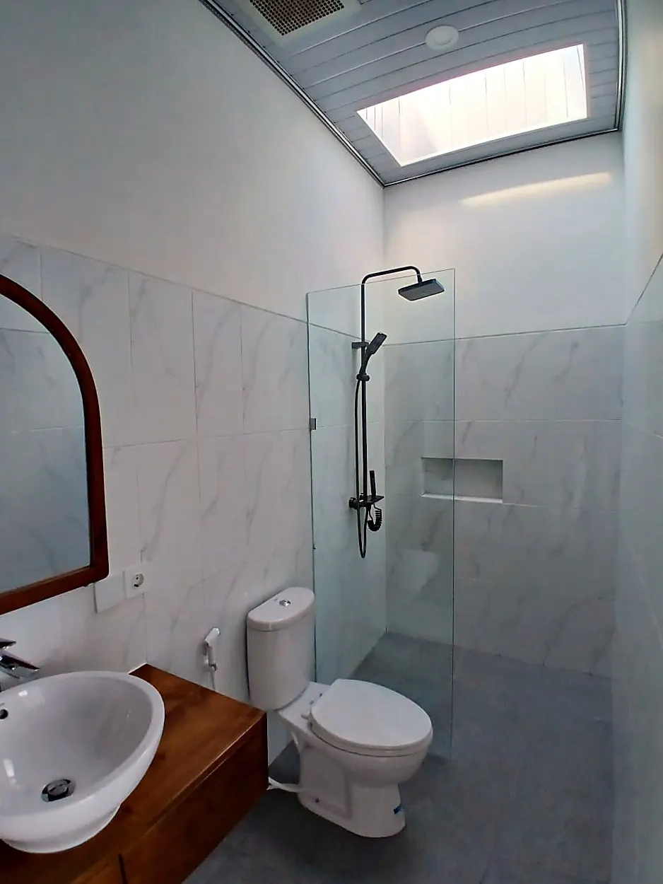 Bathroom with walk-in rain shower and skylight