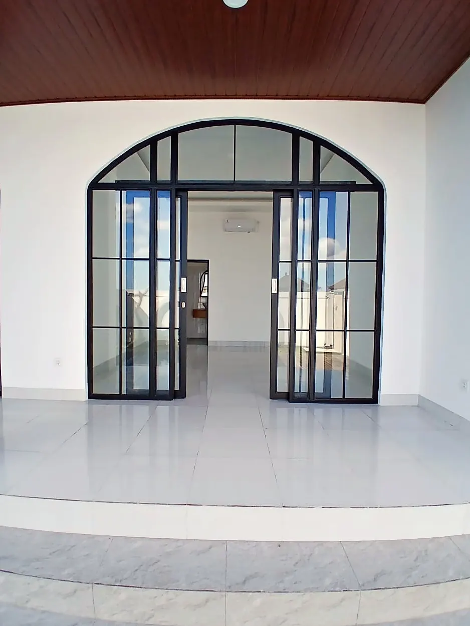 Black steel arched sliding doors from the terrace