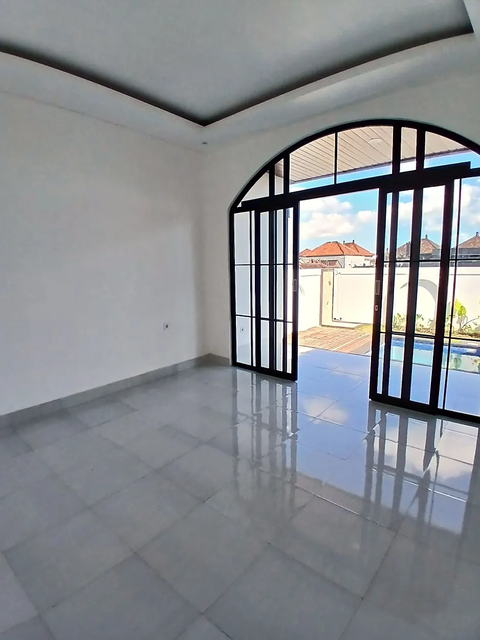 Bright open-plan interior with arched glass doors