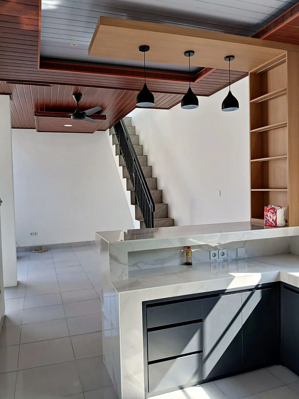 Open-plan kitchen with stairs to the rooftop
