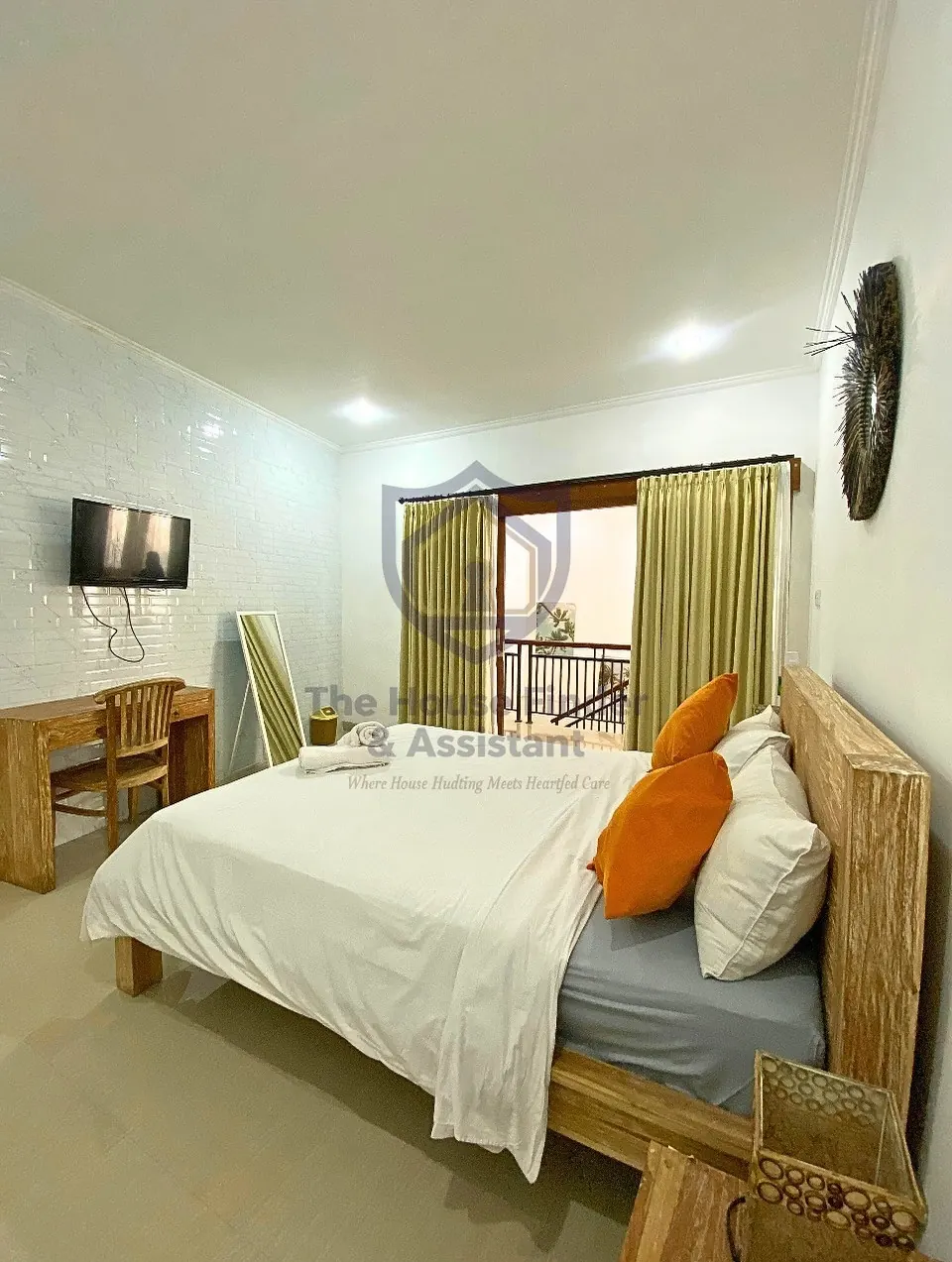 Bedroom with wall-mounted TV, desk and balcony doors