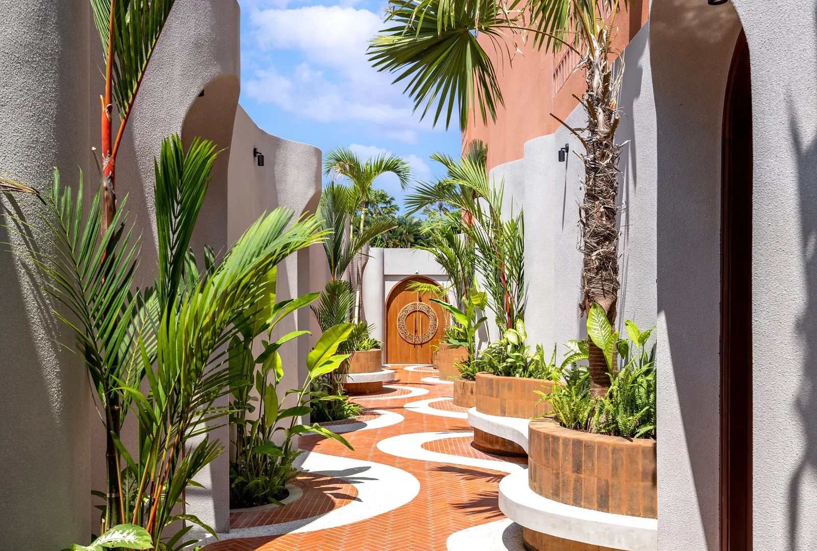 Garden pathway with herringbone brick and curved planters