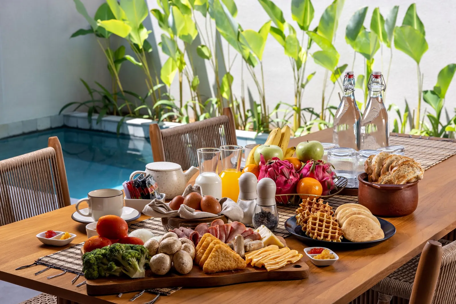 Breakfast table set by the pool