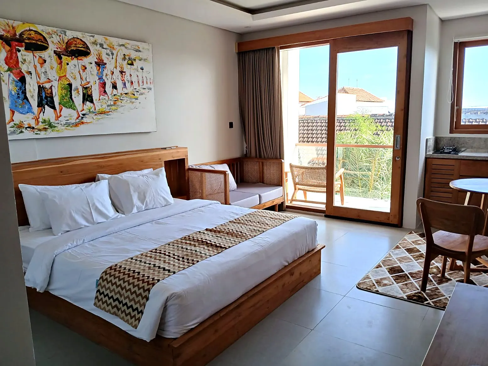 Bed with Balinese painting and balcony door