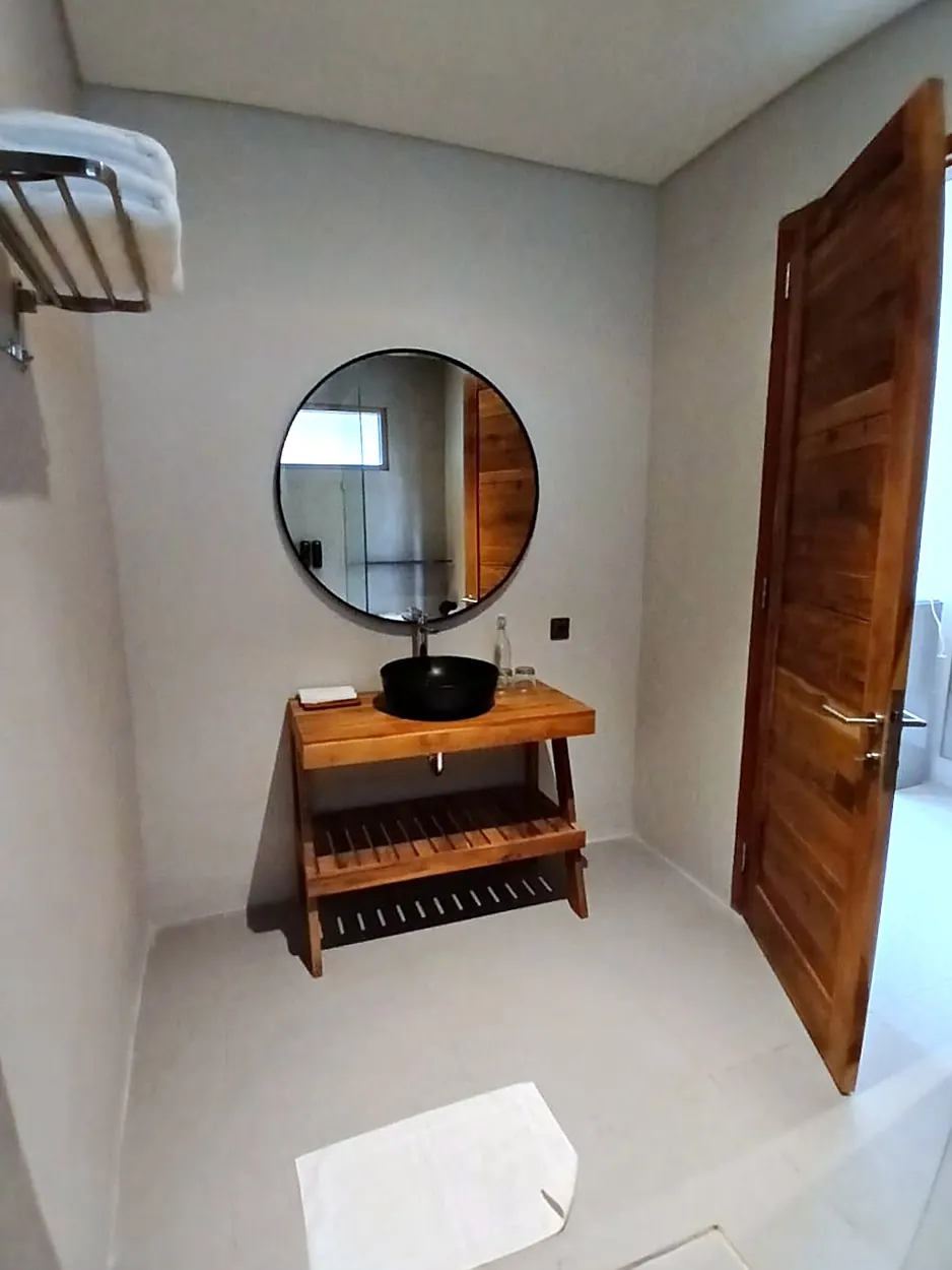 Bathroom vanity with round mirror and black basin